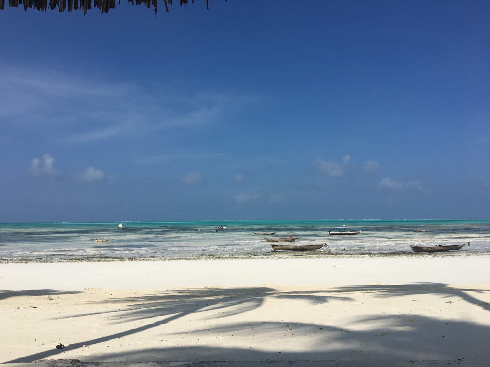 White sand, wooden boats and turquoise shallows at Jambiani, Zanzibar