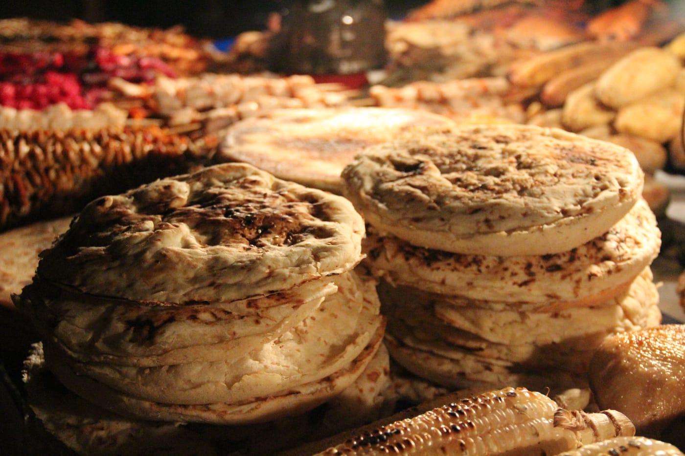 Freshly baked Zanzibari flatbreads stacked at a market stall